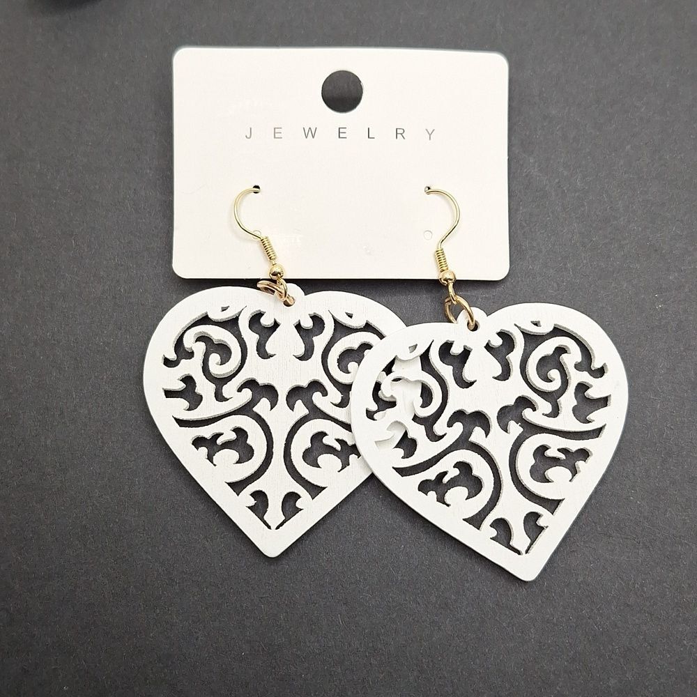 White heart shaped wood earrings carved design
